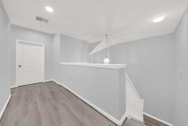 corridor featuring hardwood / wood-style floors