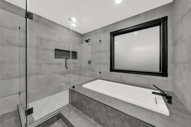 bathroom with shower with separate bathtub