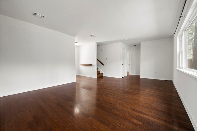 unfurnished living room featuring dark hardwood / wood-style flooring