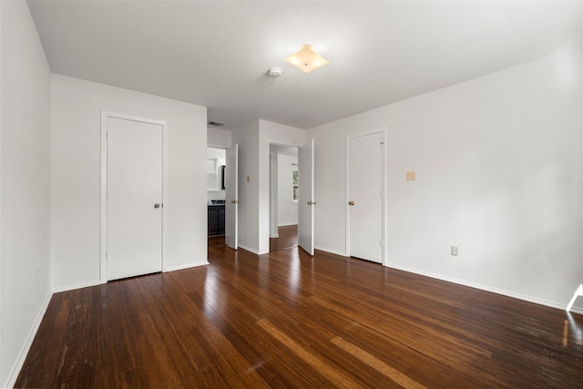 empty room featuring dark wood-type flooring