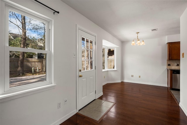 doorway featuring dark hardwood / wood-style floors and a notable chandelier