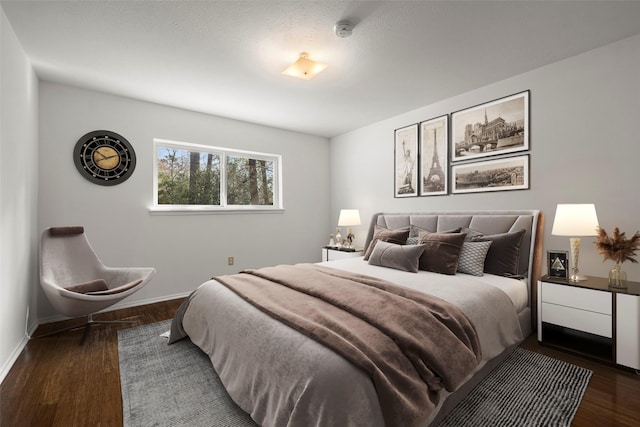 bedroom with dark hardwood / wood-style floors