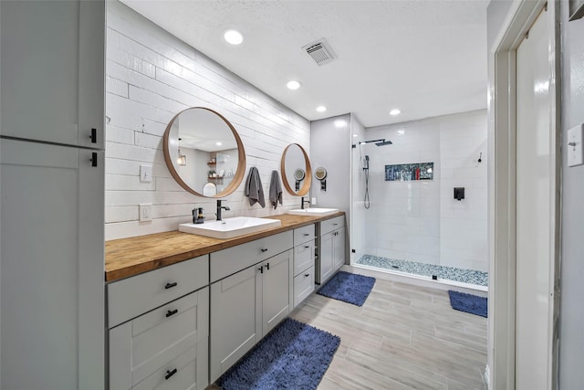 bathroom with tasteful backsplash, vanity, and walk in shower