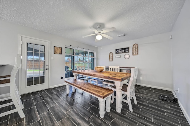 dining space featuring a textured ceiling and ceiling fan