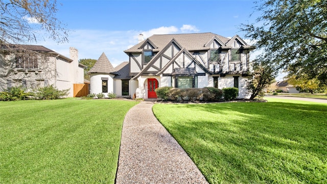 english style home with a front lawn