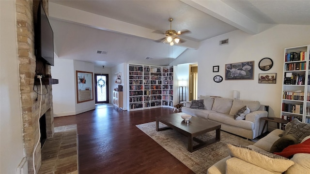 living room featuring a fireplace, dark wood-type flooring, lofted ceiling with beams, and ceiling fan