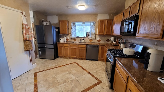 kitchen featuring light tile patterned flooring, sink, a textured ceiling, decorative backsplash, and black appliances