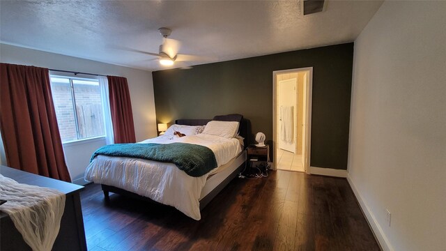 bedroom featuring a textured ceiling, dark hardwood / wood-style floors, and ceiling fan