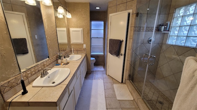 bathroom featuring vanity, an enclosed shower, tile patterned floors, and toilet