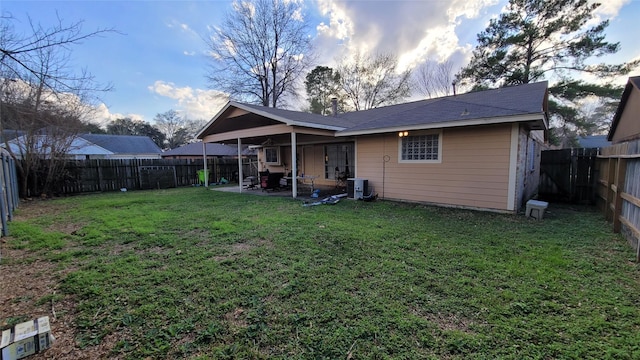 back of property featuring cooling unit, a lawn, and a patio