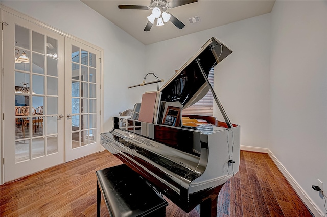 misc room with french doors, wood finished floors, visible vents, and baseboards