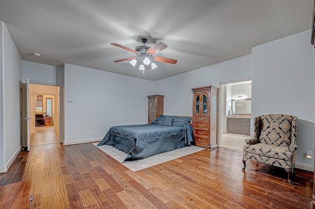 bedroom with a ceiling fan, baseboards, and wood finished floors