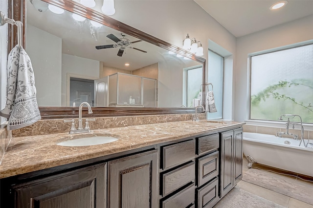 bathroom featuring double vanity, a stall shower, a sink, and a bath