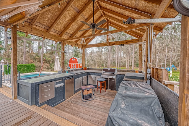 wooden terrace with a ceiling fan, a sink, and a gazebo