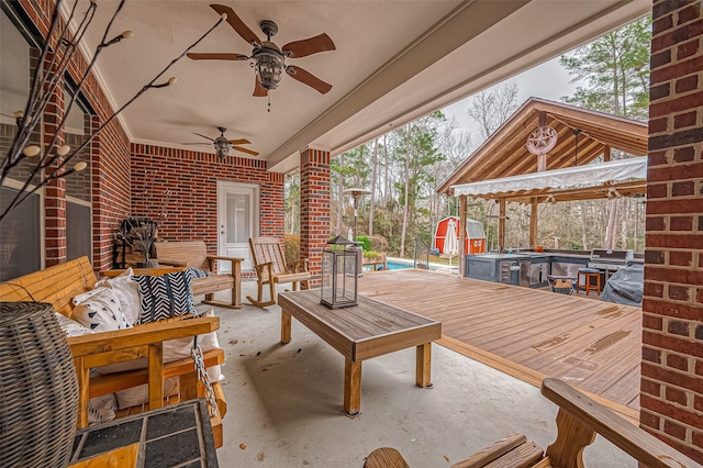 view of patio with an outdoor pool, a ceiling fan, an outbuilding, a wooden deck, and a shed