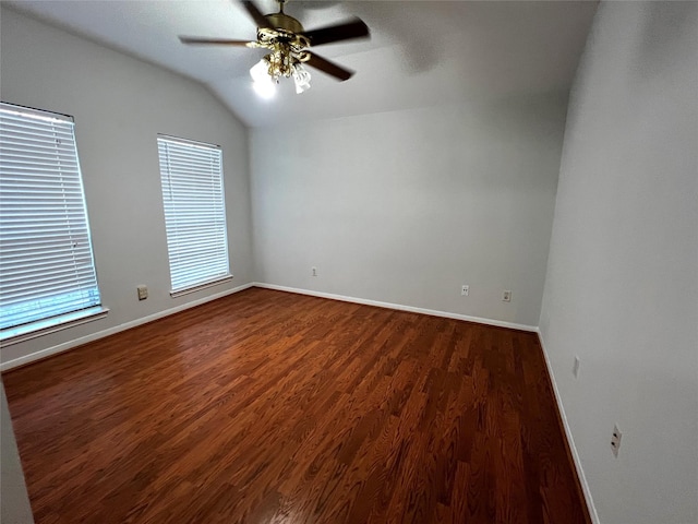 unfurnished room featuring ceiling fan, dark hardwood / wood-style floors, and vaulted ceiling