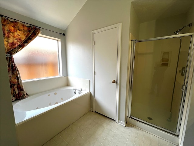 bathroom featuring vaulted ceiling and shower with separate bathtub