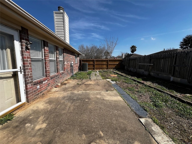 view of yard with cooling unit and a patio area