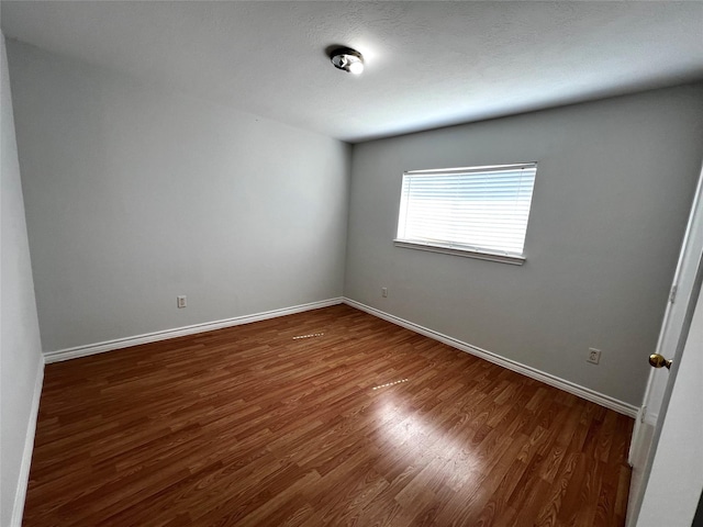 empty room featuring dark wood-type flooring