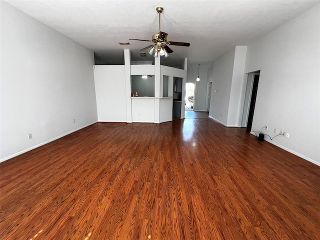 unfurnished living room featuring dark wood-type flooring and ceiling fan