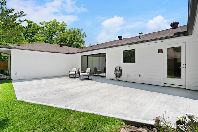 rear view of house featuring a lawn and a patio area