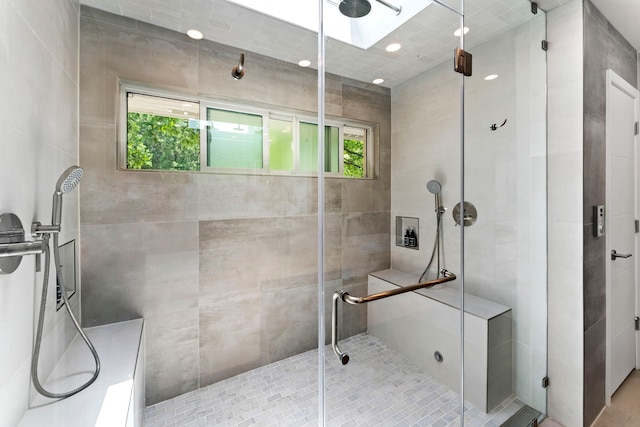 bathroom featuring an enclosed shower and a skylight