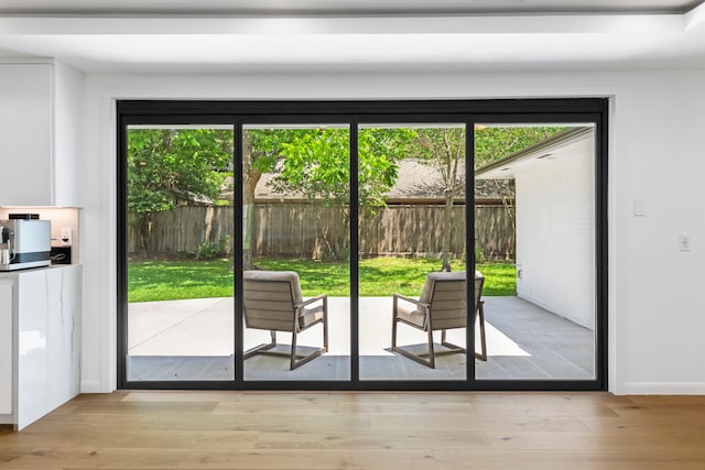 doorway with light hardwood / wood-style flooring