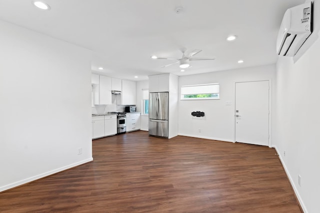 unfurnished living room featuring dark hardwood / wood-style flooring, ceiling fan, and a wall mounted AC