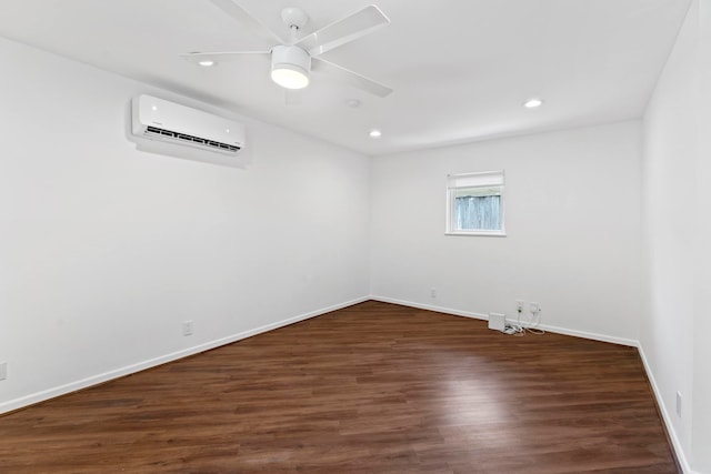 unfurnished room featuring dark hardwood / wood-style flooring, a wall mounted air conditioner, and ceiling fan