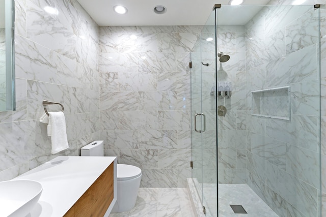 bathroom featuring an enclosed shower, vanity, and toilet