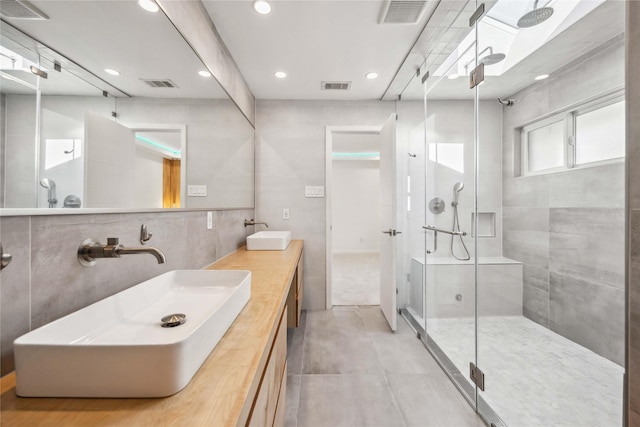 bathroom featuring vanity, tile walls, and walk in shower