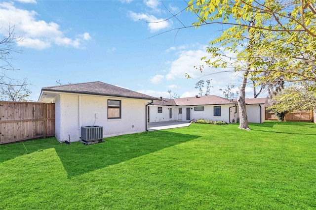 back of property featuring central AC, a lawn, and a patio area