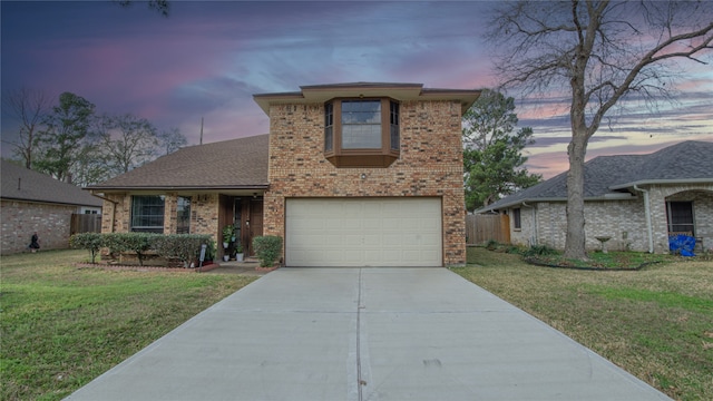 view of front facade with a garage and a yard