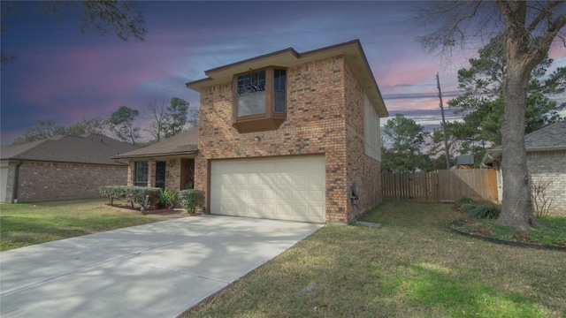 front facade featuring a garage and a lawn