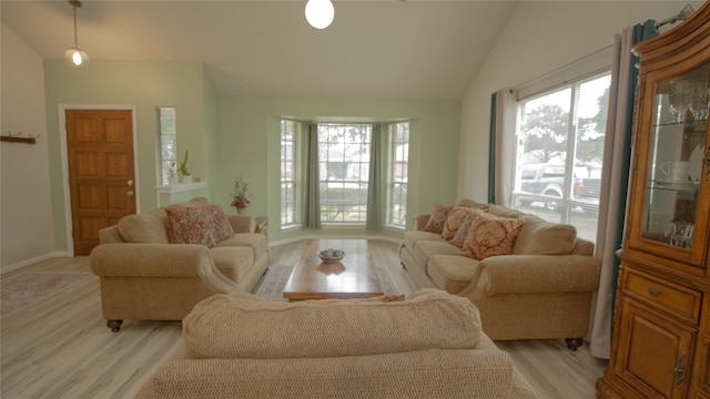 living room featuring vaulted ceiling and light hardwood / wood-style flooring