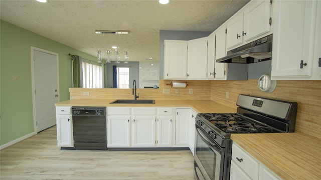 kitchen featuring dishwasher, sink, white cabinets, and stainless steel gas stove