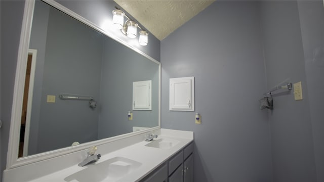 bathroom with vanity and a textured ceiling