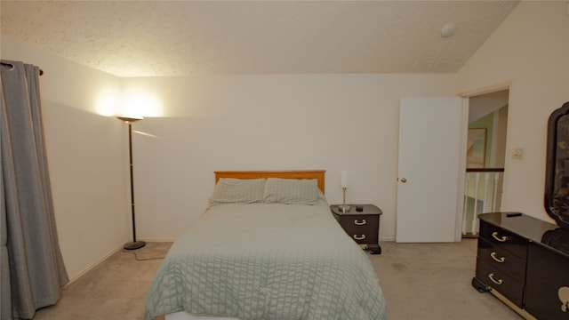 carpeted bedroom featuring vaulted ceiling and a textured ceiling