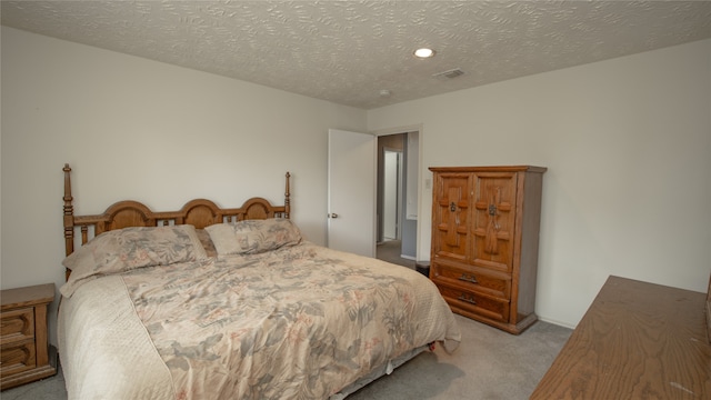 carpeted bedroom featuring a textured ceiling