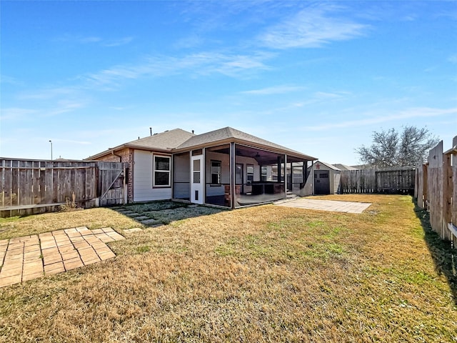 back of property featuring a sunroom, a patio, and a lawn