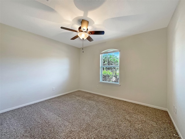 spare room featuring ceiling fan and carpet floors