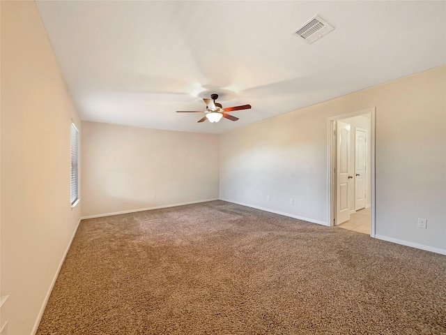 carpeted spare room featuring ceiling fan