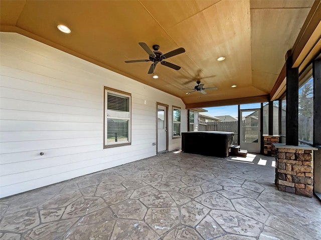 view of patio featuring a lanai, a hot tub, and ceiling fan