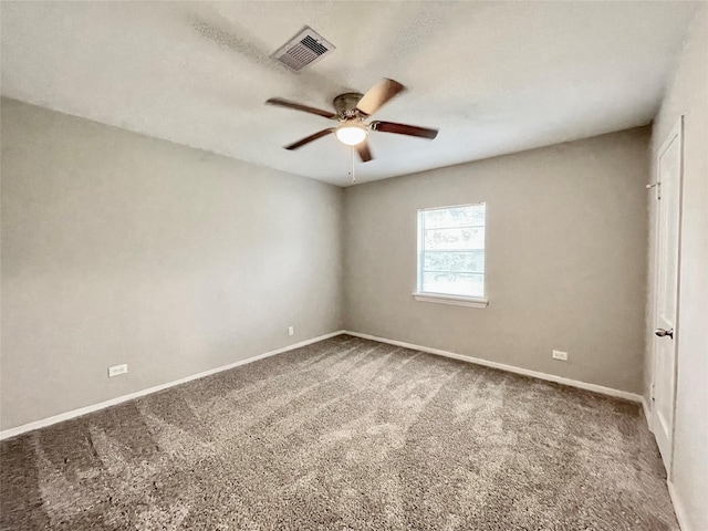 carpeted spare room with ceiling fan