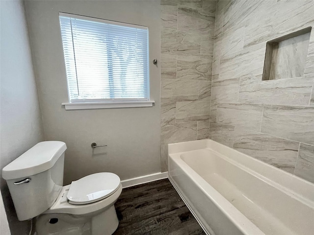 bathroom featuring toilet, hardwood / wood-style floors, and a washtub