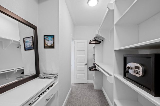 spacious closet featuring light carpet