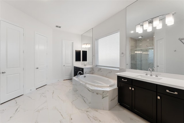 bathroom with independent shower and bath and vanity