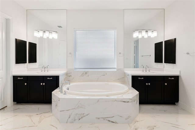 bathroom with vanity and tiled tub