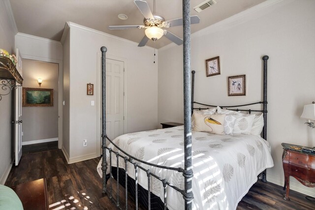 bedroom with dark hardwood / wood-style flooring, crown molding, and ceiling fan