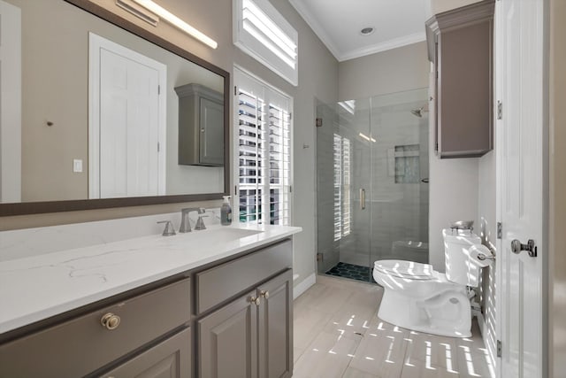 bathroom featuring a shower with door, ornamental molding, vanity, and toilet